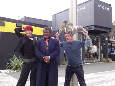 Guarding the City: a group of actors in front of a container bank building